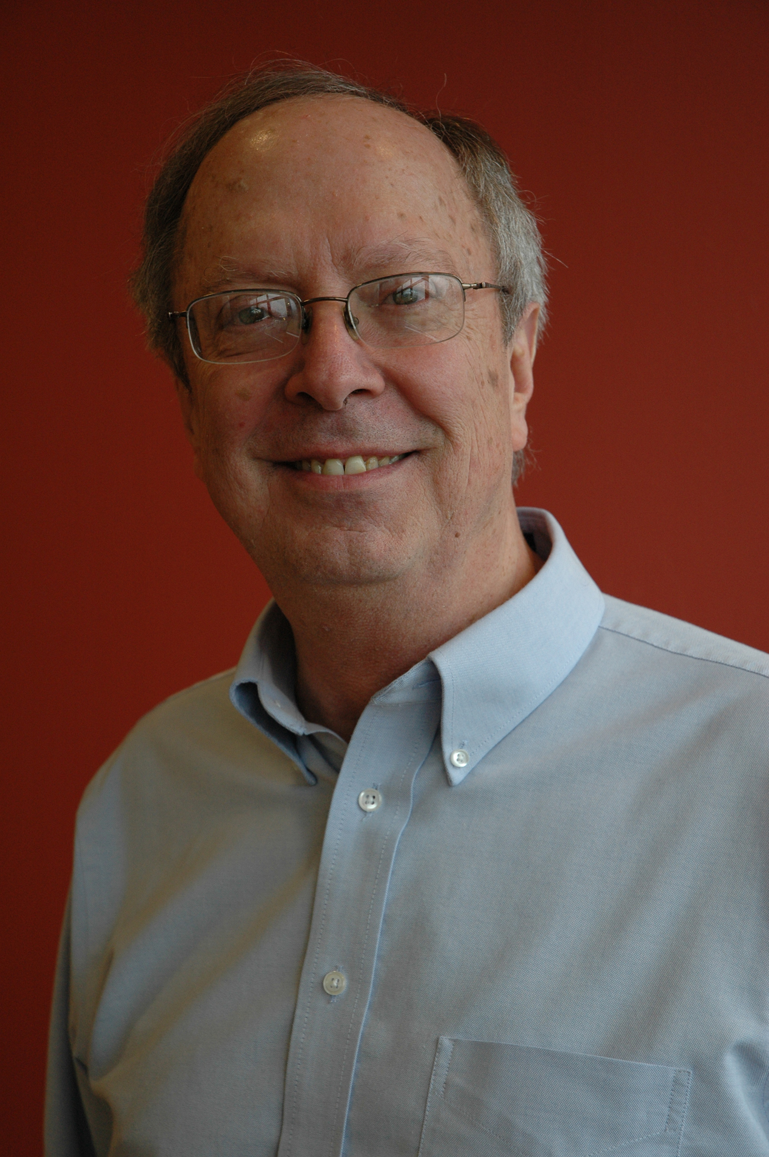 Photo of Bill Bengston with a reddish background