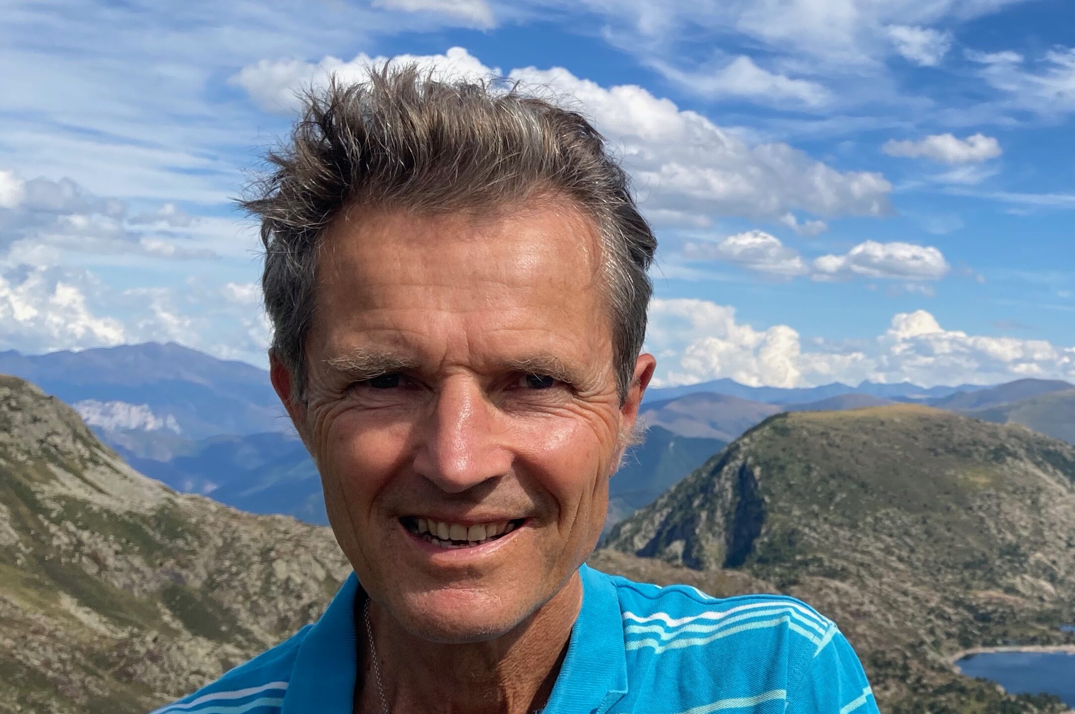 Photo of David Lorimer with a mountainous landscape in the background