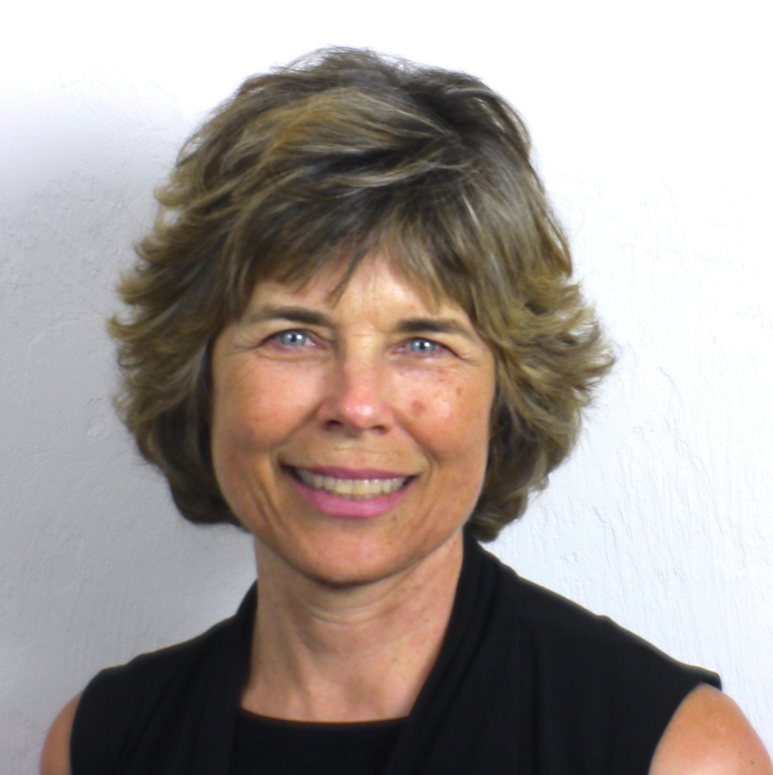 Photo of Marjorie Woollacott in front of a white wall