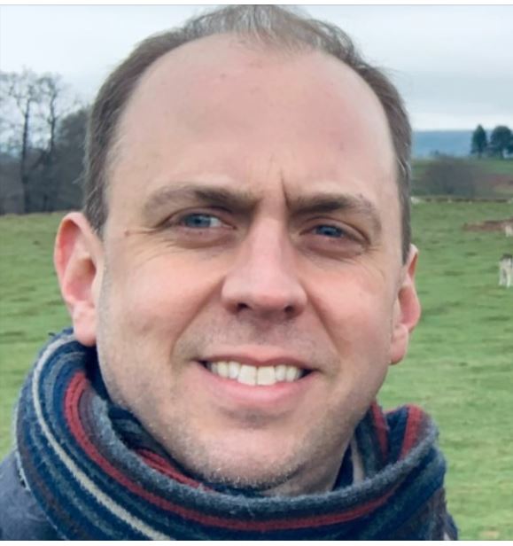 Photo of Oliver Robinson in a green meadow